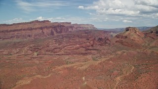 AX137_098E - 5.5K aerial stock footage approach Fisher Towers at base of mesa with rock formations, Utah