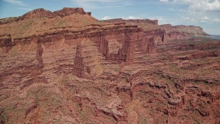AX137_101E - 5.5K aerial stock footage of Ancient Art, Echo Tower, Cottontail Tower, The Titan rock formations, Fisher Towers, Utah