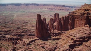 AX137_103E - 5.5K aerial stock footage of orbiting The Titan near other rock formations at Fisher Towers, Utah