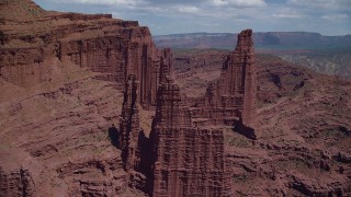 AX137_107 - 5.5K stock footage aerial video flyby Ancient Art to approach The Titan and other rock formations at Fisher Towers, Utah