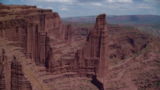 AX137_108 - 5.5K stock footage aerial video of approaching The Titan rock formation at Fisher Towers, Utah