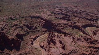 AX137_124 - 5.5K stock footage aerial video of a dirt road through canyon in Fisher Towers, Utah