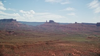 AX137_125E - 5.5K aerial stock footage of a view of distant desert buttes in Moab, Utah