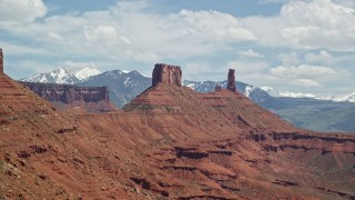 AX137_129E - 5.5K aerial stock footage of an approach to a desert butte and Castleton Tower in Moab, Utah