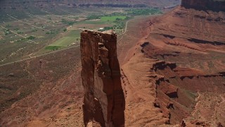 AX137_140 - 5.5K aerial stock footage of rock climbers on Castleton Tower in Moab, Utah