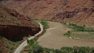 AX137_158 - 5.5K aerial stock footage of State Route 128 and rapids on the Colorado River in Moab, Utah