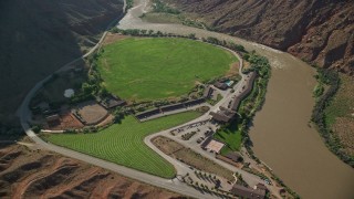 AX138_004E - 5.5K aerial stock footage tilt to bird's eye view of Red Cliffs Lodge beside the Colorado River in Moab, Utah