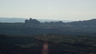 AX138_009E - 5.5K aerial stock footage of desert buttes and and natural arches in Arches National Park, Utah