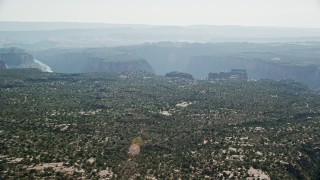 AX138_019 - 5.5K aerial stock footage of a wide view of Big Bend Canyon in Arches National Park seen from flat desert, Utah