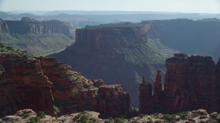 AX138_024 - 5.5K aerial stock footage fly over cliff to reveal Colorado River and Big Bend, Arches National Park, Utah