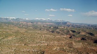 AX138_030 - 5.5K aerial stock footage of a wide view of a desert landscape, canyon and mesas, Moab, Utah