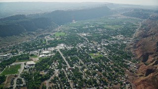 AX138_040 - 5.5K aerial stock footage of a small desert town, Moab, Utah