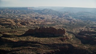 AX138_043E - 5.5K aerial stock footage of approaching desert rock formations, Moab, Utah