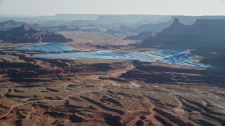 AX138_057 - 5.5K aerial stock footage of blue potash ponds in the desert, Moab, Utah