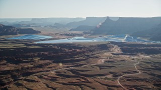 AX138_058 - 5.5K aerial stock footage of passing by industrial potash ponds in the desert, Moab, Utah