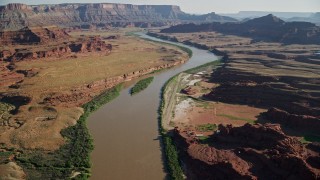 AX138_059E - 5.5K aerial stock footage fly over Colorado River and approach Pyramid Butte, Moab, Utah