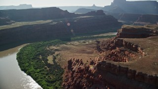 AX138_070E - 5.5K aerial stock footage of flying over Colorado River flowing through Meander Canyon, Moab, Utah