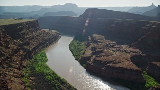 AX138_073E - 5.5K aerial stock footage of the Colorado River flowing through Meander Canyon, Canyonlands National Park, Utah