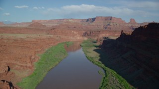 AX138_087 - 5.5K aerial stock footage follow Colorado River in Goose Neck Area with mesas in the distance, Meander Canyon, Canyonlands National Park, Utah
