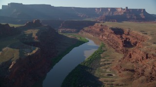 AX138_111 - 5.5K aerial stock footage of the Colorado River and Meander Canyon near buttes and mesas, Canyonlands National Park, Utah