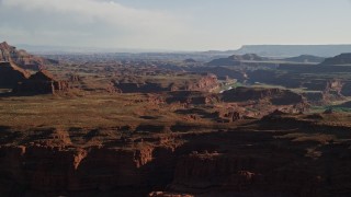 AX138_112 - 5.5K aerial stock footage of passing Pyramid Butte and Meander Canyon in Canyonlands National Park, Utah