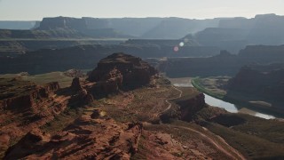 AX138_113 - 5.5K aerial stock footage of passing a butte overlooking Meander Canyon and Colorado River, Canyonlands National Park, Utah