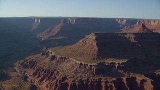 AX138_117 - 5.5K aerial stock footage of mesas and buttes seen across Shafer Canyon in Canyonlands National Park, Utah