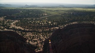 AX138_121 - 5.5K aerial stock footage approach Grand View Point Road from Shafer Canyon in Canyonlands National Park, Utah