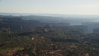 AX138_124 - 5.5K aerial stock footage of flying by Taylor Canyon in Canyonlands National Park, Utah