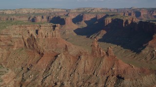 AX138_140 - 5.5K aerial stock footage of Zeus and Moses Butte in Taylor Canyon, Canyonlands National Park, Utah