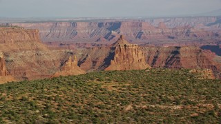 AX138_148E - 5.5K aerial stock footage of two buttes in Shafer Canyon, Canyonlands National Park, Utah