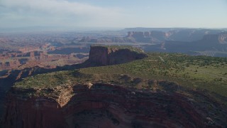 AX138_155 - 5.5K stock footage aerial video of the Dead Horse Point Overlook, with Canyonlands National Park in the background, Utah