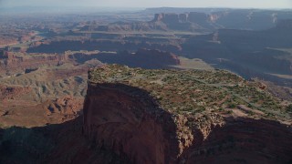 AX138_157 - 5.5K aerial stock footage approach and tilt to cars parked on Dead Horse Point Overlook with view of Canyonlands National Park, Utah