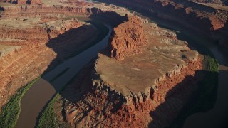 AX138_160E - 5.5K aerial stock footage of a reverse view of the Goose Neck in Meander Canyon, Canyonlands National Park, Utah
