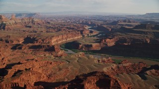 AX138_168E - 5.5K aerial stock footage of desert mesas by Meander Canyon and Colorado River in Moab, Utah