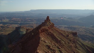 AX138_176 - 5.5K aerial stock footage orbit small butte with wide view of Canyonlands National Park, Utah