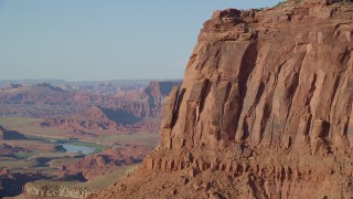 AX138_192 - 5.5K stock footage aerial video approach a cliffside rock formation in Moab, Utah