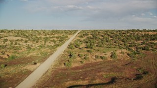 AX138_215E - 5.5K aerial stock footage of a bend in Hatch Point Road through the desert near Moab, Utah