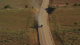 AX138_223 - 5.5K aerial stock footage track a silver SUV on Hatch Point Road, Moab, Utah