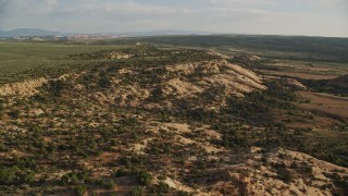 AX138_238E - 5.5K aerial stock footage of flying by shallow canyon seen from Hatch Point, Moab, Utah