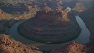 AX138_293 - 5.5K aerial stock footage of slow orbit of The Loop East in Meander Canyon and Colorado River, Canyonlands National Park, Utah, sunset
