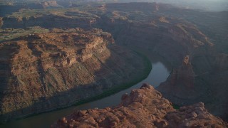 AX138_296 - 5.5K aerial stock footage pass The Loop West in Meander Canyon, and Colorado River, Canyonlands National Park, Utah, sunset