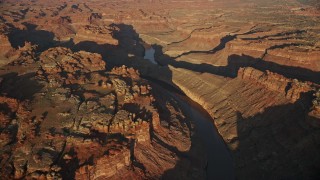 AX138_300E - 5.5K aerial stock footage orbit The Loop West, The Loop East parts of Meander Canyon and Colorado River, Canyonlands National Park, Utah, sunset