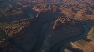 AX138_303 - 5.5K aerial stock footage of The Loop West, The Loop East parts of Meander Canyon and Colorado River, Canyonlands National Park, Utah, sunset