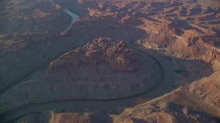 AX138_305 - 5.5K aerial stock footage orbiting the river in The Loop East part of Meander Canyon, Canyonlands National Park, Utah, sunset