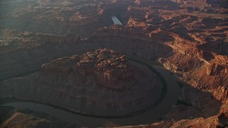 AX138_306E - 5.5K aerial stock footage of the Colorado River in The Loop East, Meander Canyon, Canyonlands National Park, Utah, sunset