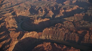 AX138_316 - 5.5K aerial stock footage of slowly orbiting the river in Meander Canyon, Canyonlands National Park, Utah, sunset