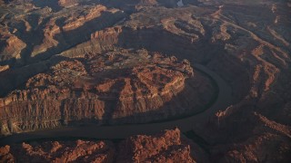 AX138_317E - 5.5K aerial stock footage of The Loop West, Meander Canyon, and Colorado River at sunset, Canyonlands National Park, Utah