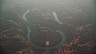 AX138_333E - 5.5K aerial stock footage circling Colorado River in Meander Canyon at sunset, Canyonlands National Park, Utah