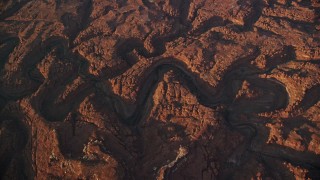 AX138_336E - 5.5K aerial stock footage bird's eye view of dry riverbeds through rocky canyons, Canyonlands National Park, Utah, sunset